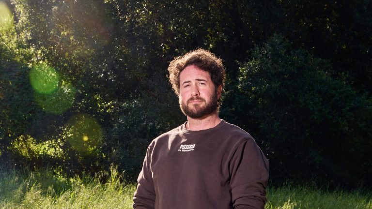 A conceptual image showing a solo entrepreneur using AI tools to manage a massive telehealth logistics network.