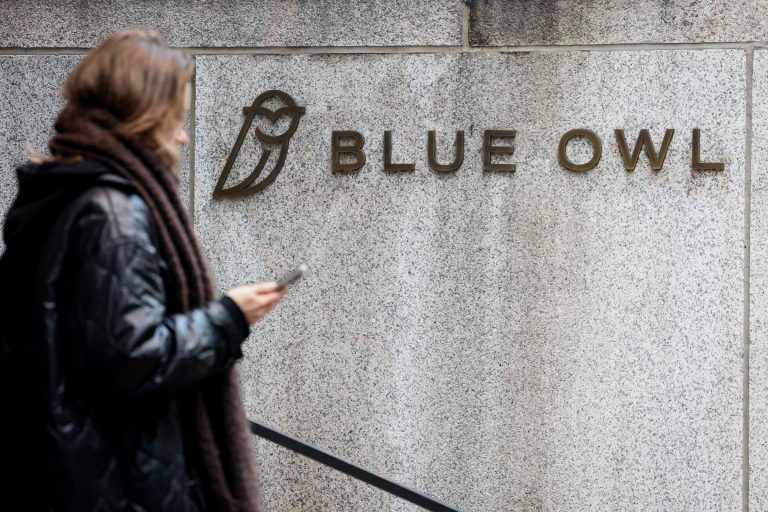 A high-rise office building representing Blue Owl Capital with an overlay of a declining financial line graph.
