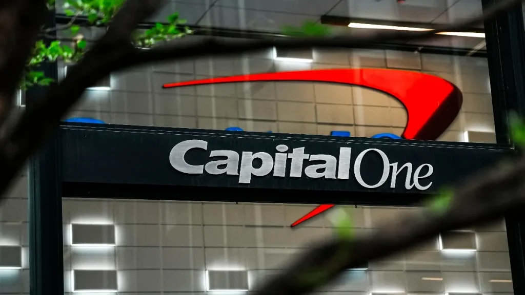 A person reviewing their banking app on a smartphone with a graphical overlay showing an upward trend in savings interest.